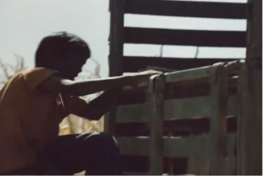 Figure 2: Bāshū jumping into the back of a truck where he falls asleep. Frame enlargement of a screenshot from the film Bashu, The Little Stranger (Bāshū, Gharībah-yi Kūchak), directed by Bahrām Bayzā’ī, 1986 (00:03:48).