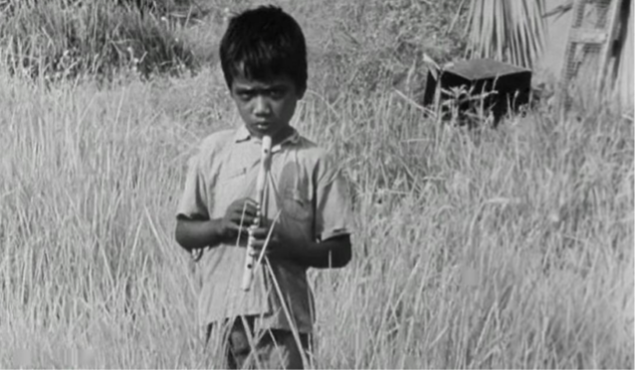 Figure 6: The street boy playing the flute. Frame enlargement from the film Two, directed by Satyajit Ray, 1964 (00:03:56).