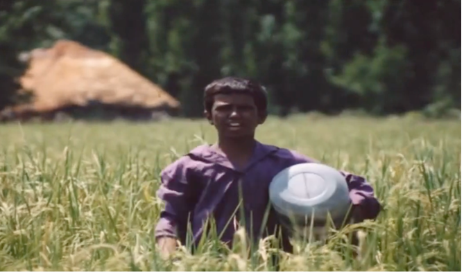 Figure 10: Bāshū playing the drum to help the plant grow better. Frame enlargement of a screenshot from the film Bashu, The Little Stranger (Bāshū, Gharībah-yi Kūchak), directed by Bahrām Bayzā’ī, 1986 (01:23:29).