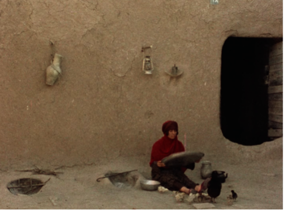 Figure 7 (left): Rūy’bakhayr sitting in the yard, preparing rice for cooking. Still from The Sealed Soil (Khāk-i sar bih muhr), directed by Marvā Nabīlī, 1977.