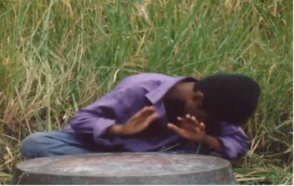 Figure 12: Bāshū playing the Zār drum to heal Nā’ī, who is suffering from fever. Frame enlargement of a screenshot from the film Bashu, The Little Stranger (Bāshū, Gharībah-yi Kūchak), directed by Bahrām Bayzā’ī, 1986 (01:39:48).
