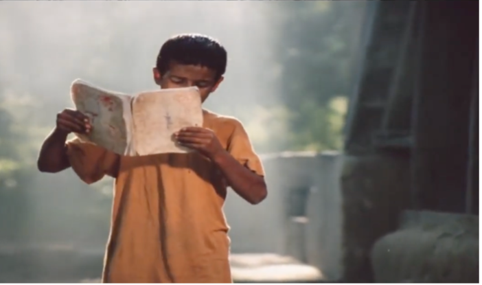 Figure 15: Bāshū finds a Persian educational book and reads a touching passage, which makes the other children sympathize with him. Frame enlargement of a screenshot from the film Bashu, The Little Stranger (Bāshū, Gharībah-yi Kūchak), directed by Bahrām Bayzā’ī, 1986 (00:58:38).
