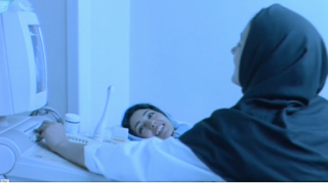 Figure 5: Sipīdah hearing the heartbeat of the baby in her womb. Still from M for Mother (Mīm misl-i mādar), directed by Rasūl Mullāqulīpūr, 2006.