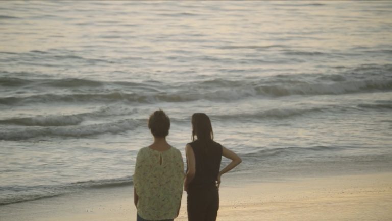 Figure 7: Zaree and Dilījānī are seen framed against the horizon, looking out over the sea. Still from Born in Evin, directed by Maryam Zaree, 2019.