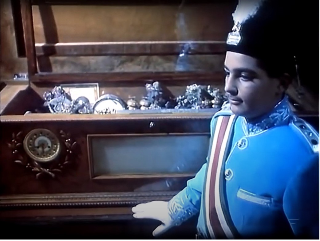 Figure 4: Ahmad Shah standing beside the music box, listening to its celestial sound, still from the film Love Stricken(Dilshudigān), directed by ‘Alī Hātamī, 1992.