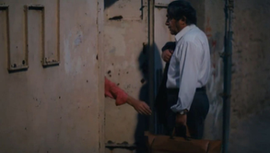 Figure 5: Nawbar extending her hand to take Rasūl’s bag. Still from The Blue-Veiled (Rūsārī Ābī), directed by Rakhshān Banī-I‛timād, 1995 (00:54:41).