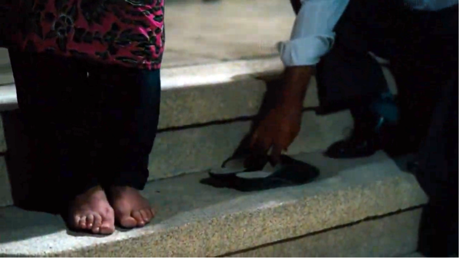 Figure 7: Rasūl arranging Nawbar’s slippers. Still from The Blue-Veiled (Rūsārī Ābī), directed by Rakhshān Banī-I‛timād, 1995 (00:55:57).