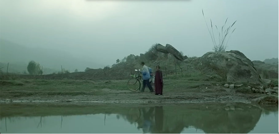 Figure 4: Agrin and the boy nicknamed Satellite search for the red fish in the pond believed to be cursed by other refugees. Turtles Can Fly(2004), directed by Bahman Ghobadi. Accessed via https://www.youtube.com/watch?v=b3uawVIxPPc (00:45:07).